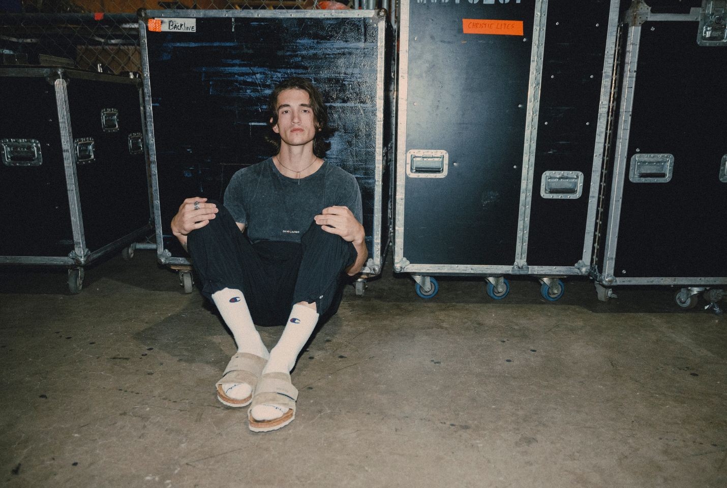 Chance Pena sat in front of some flight cases